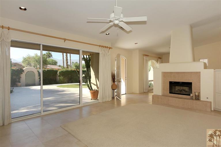 78780 Rio Seco La Quinta, CA 92253 - Photo 9 of 37 a view of an empty room with a fireplace and a window