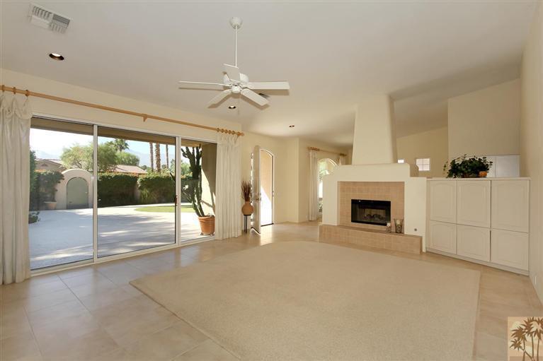 78780 Rio Seco La Quinta, CA 92253 - Photo 10 of 37 a view of an empty room with a fireplace and a floor to ceiling window