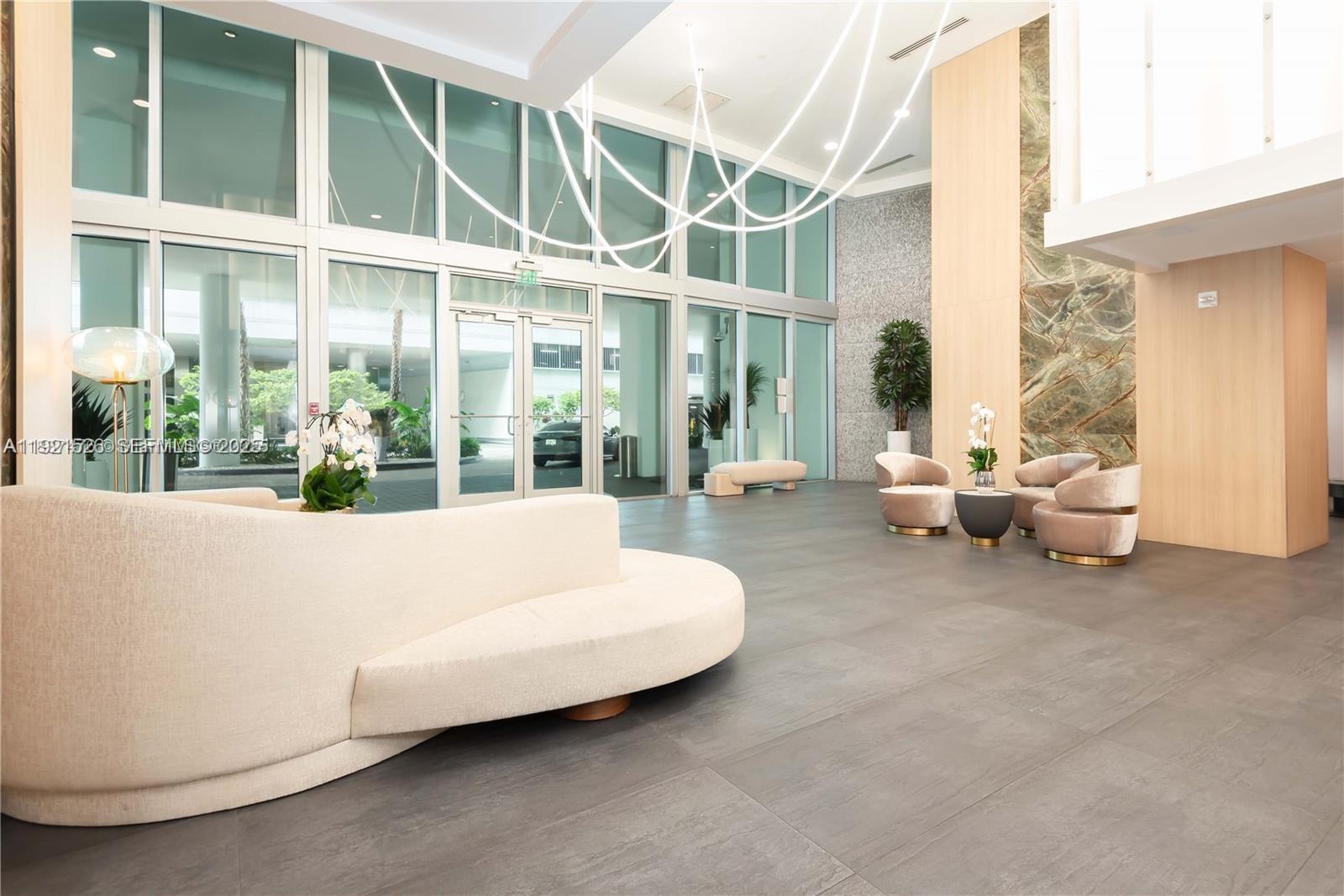 90 Southwest 3rd Street, Unit 4105 Miami, FL 33130 - Photo 5 of 27 a living room with furniture and a large window