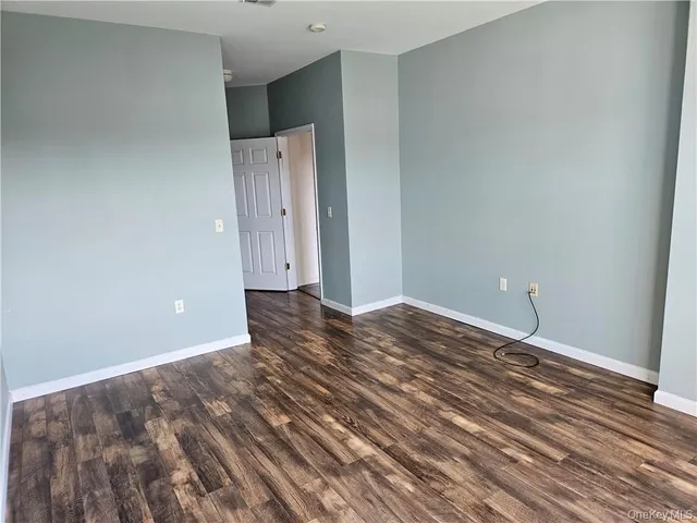 a view of a room with wooden floor