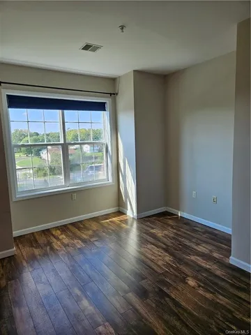 a view of an empty room and wooden floor