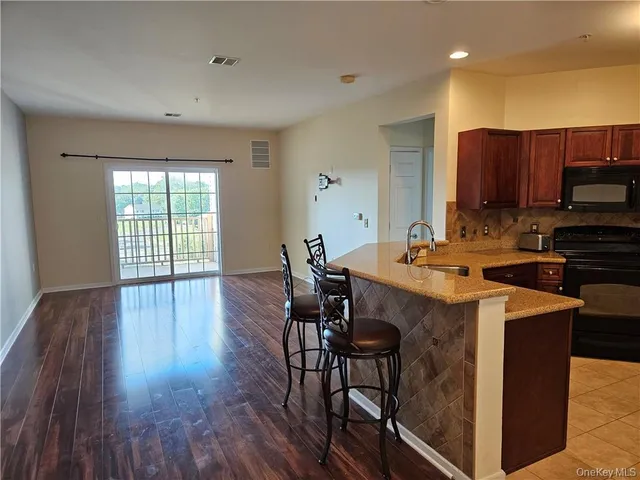 a view of room with window and wooden floor