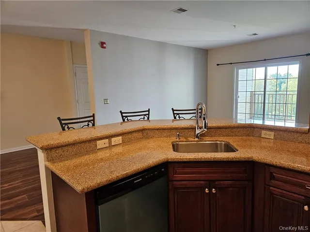 a kitchen with a sink a microwave a stove and cabinets