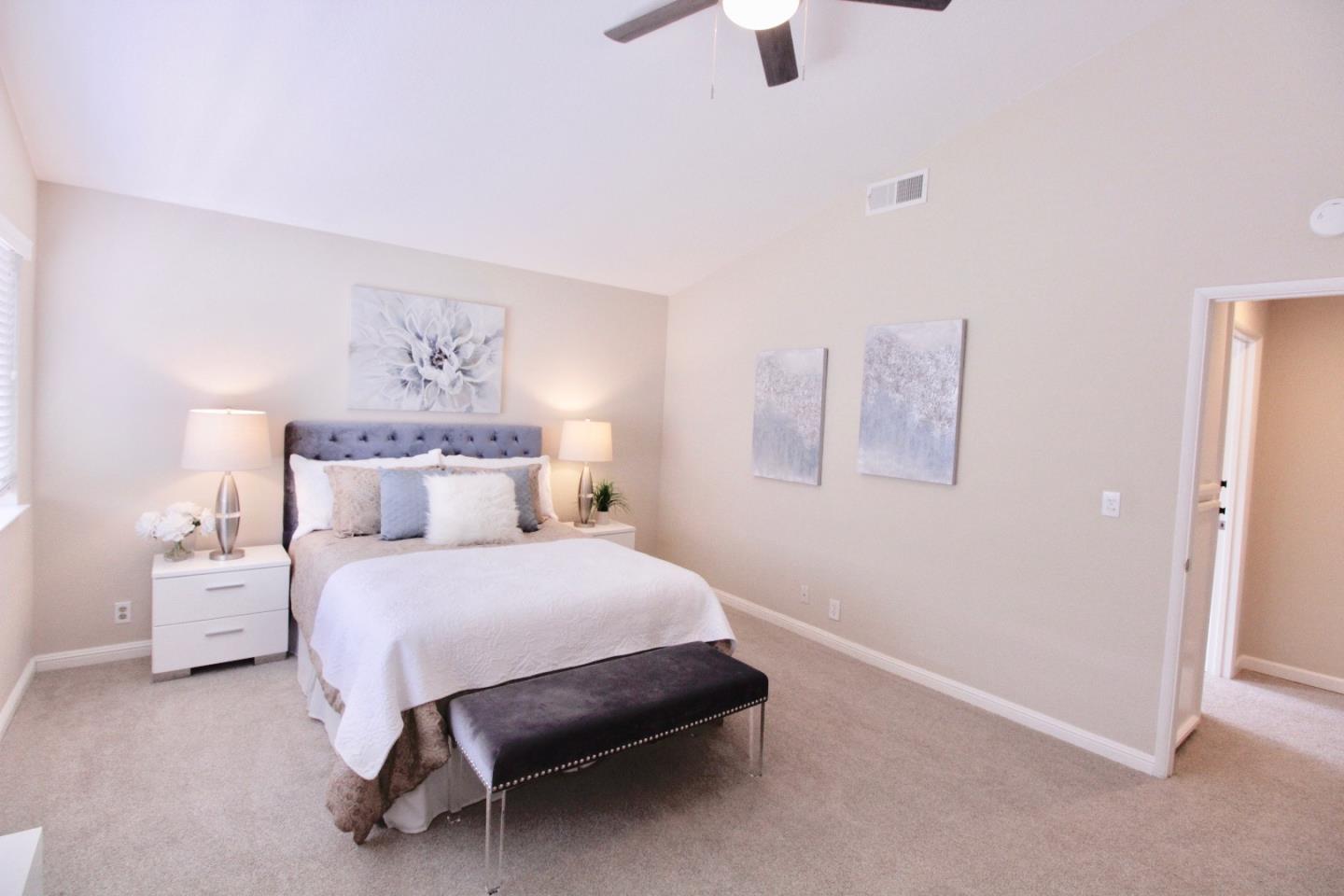 60 Cherryton Lane San Jose, CA 95136 - Photo 18 of 31 a bedroom with a bed and a chandelier