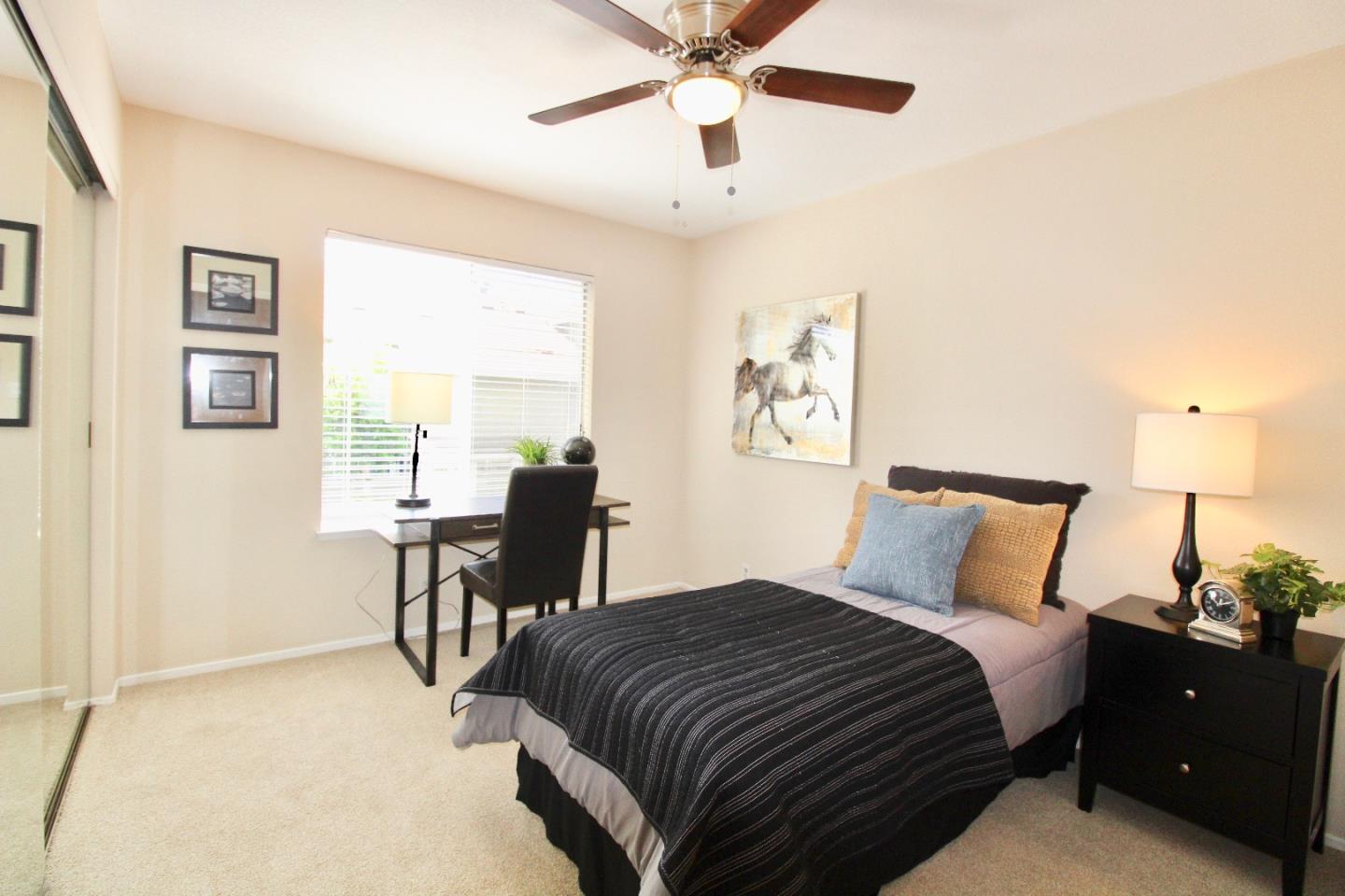 60 Cherryton Lane San Jose, CA 95136 - Photo 22 of 31 a bedroom with a bed and a table