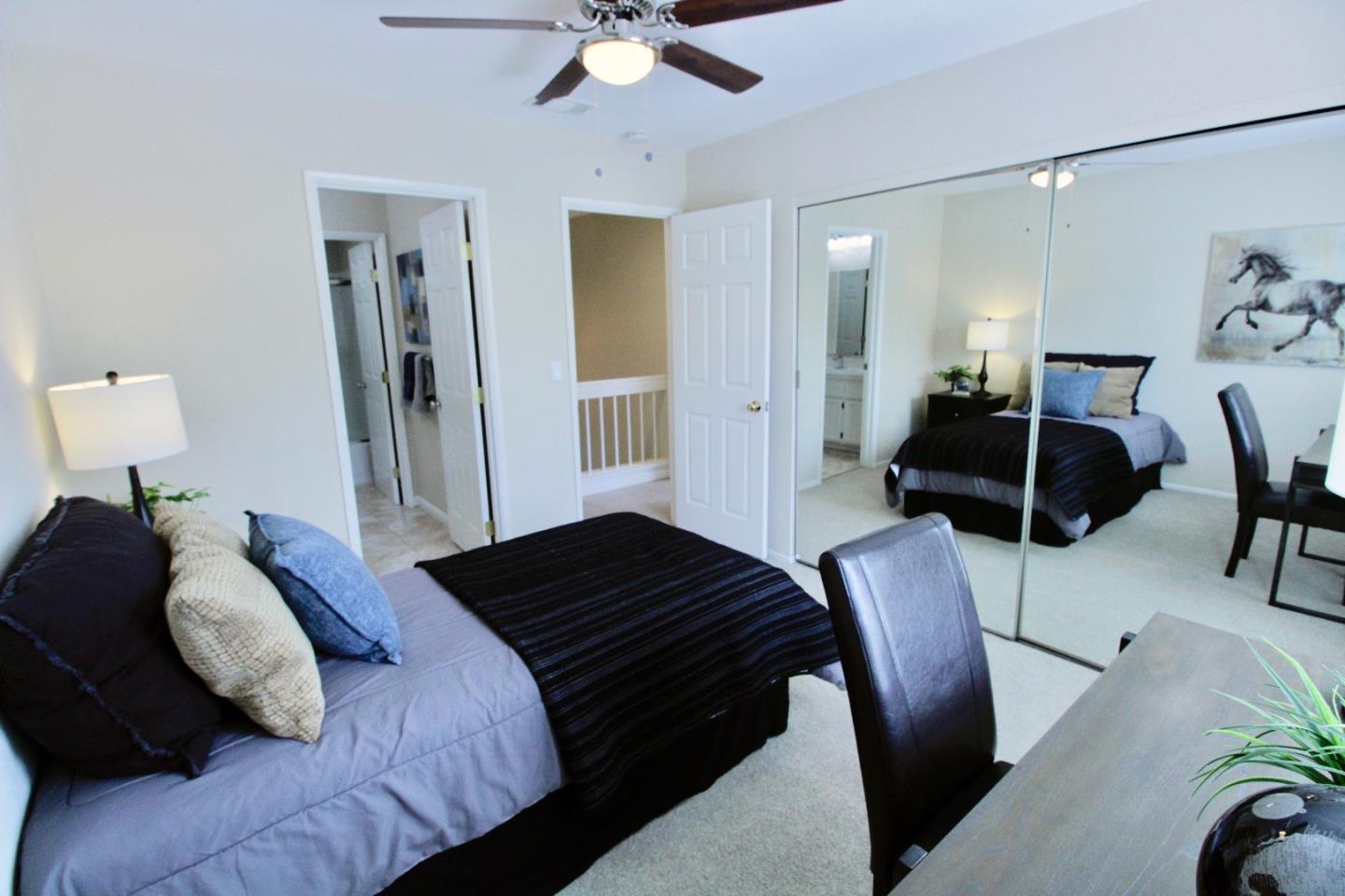 60 Cherryton Lane San Jose, CA 95136 - Photo 23 of 31 a bedroom with a bed and a chandelier
