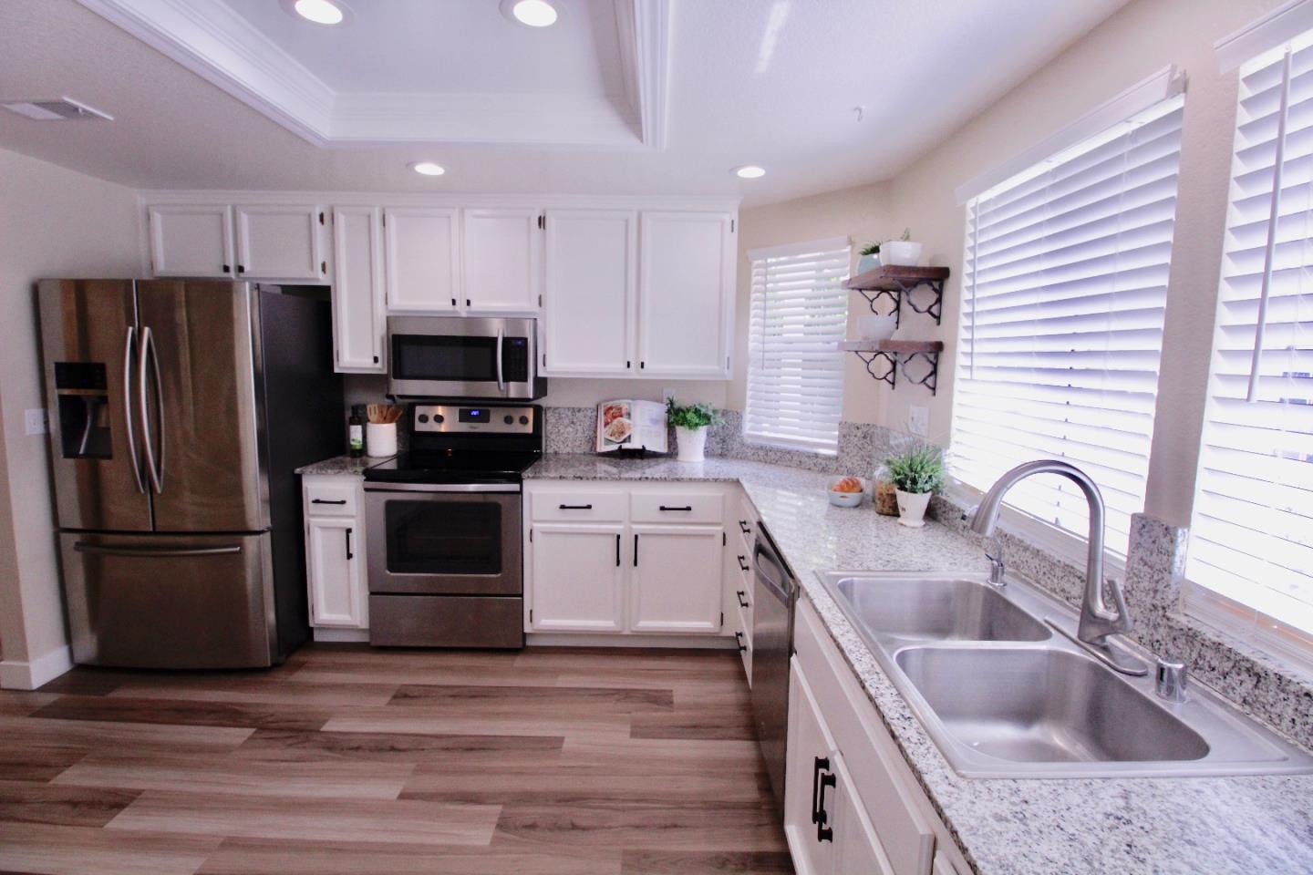 60 Cherryton Lane San Jose, CA 95136 - Photo 5 of 31 a kitchen with a sink cabinets and stainless steel appliances