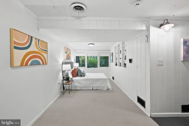 a bed room with a bed and a painting on the wall