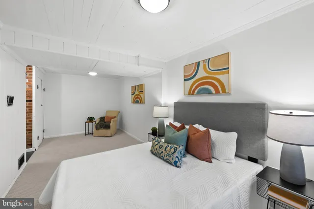 a bedroom with bed and cupboard