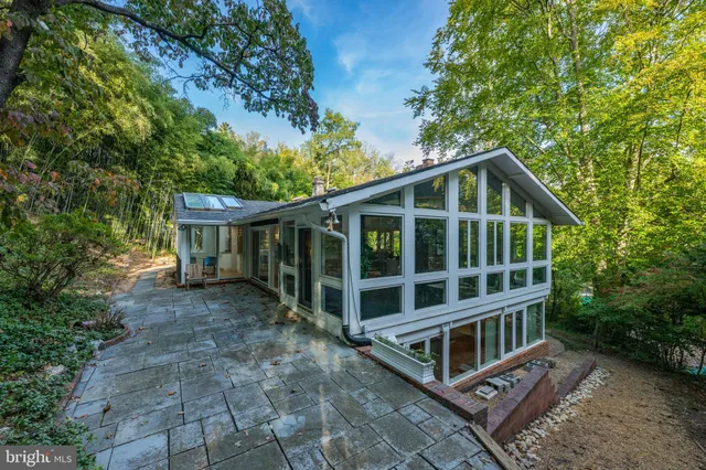 a view of a house with a yard and wooden fence