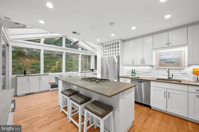 a kitchen with stainless steel appliances granite countertop a stove a sink and a refrigerator