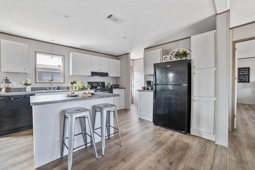 164 Ranya Loop Decatur, TX 76234 - Photo 9 of 31 a kitchen with white cabinets and stainless steel appliances