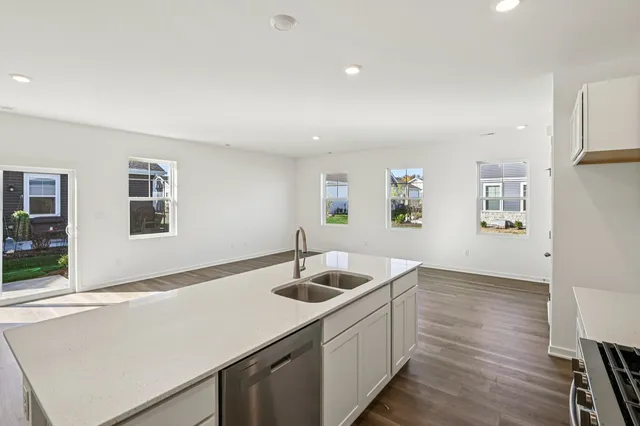 a kitchen with a sink cabinets and wooden floor