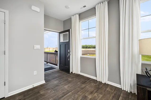 a view of hallway with wooden floor