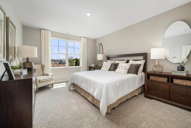 a bedroom with a bed and a large window