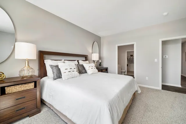 a bedroom with a bed and a lamp