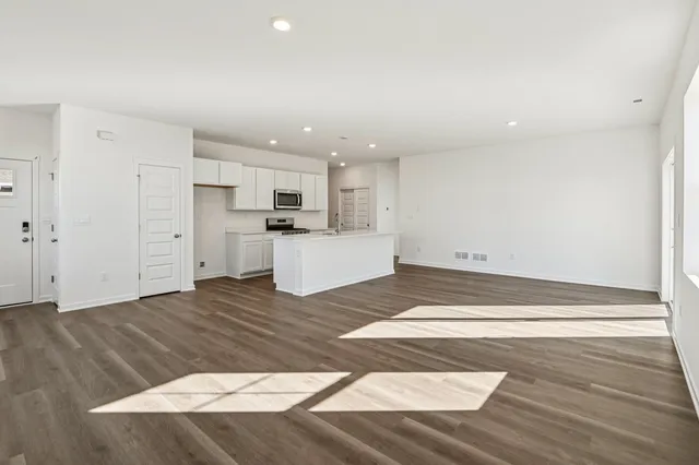 a view of kitchen with wooden floor and electronic appliances