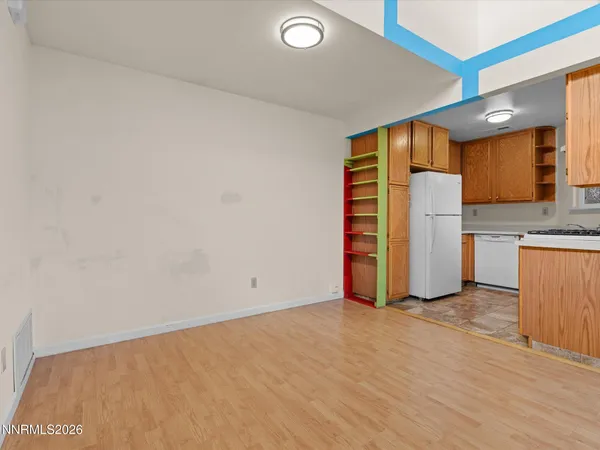 an empty room with a fireplace and cabinet