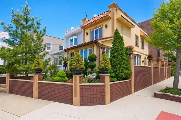 a front view of a house with trees