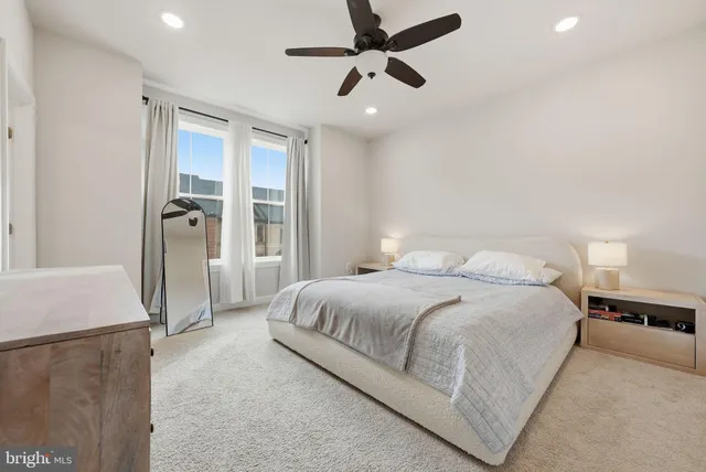 a spacious bedroom with a bed and a refrigerator