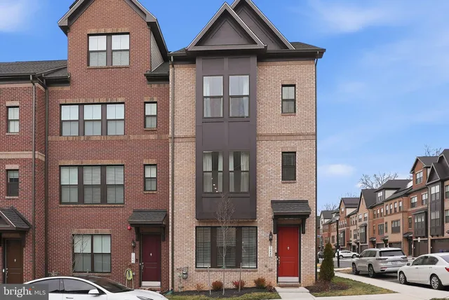 a front view of a residential apartment building with a yard