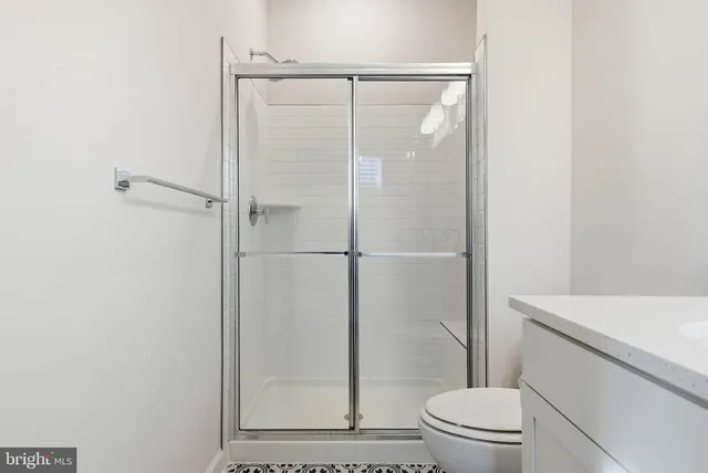 a bathroom with a shower a toilet and a sink