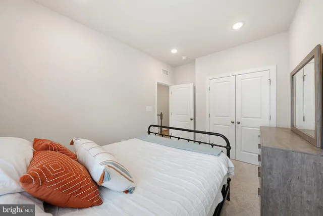 a bedroom with a bed and a couch