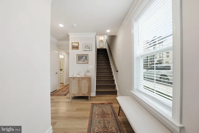 a view of entryway with wooden floor and stairs