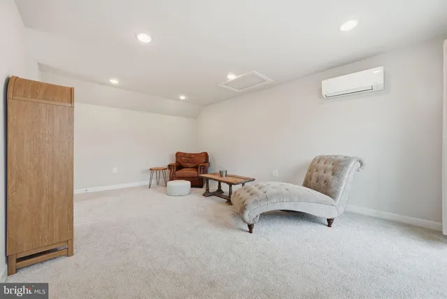 a living room with furniture and a chair