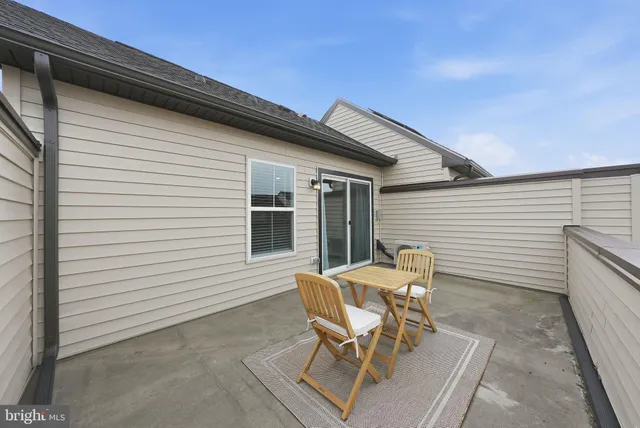 a view of a patio with table and chairs and wooden floor