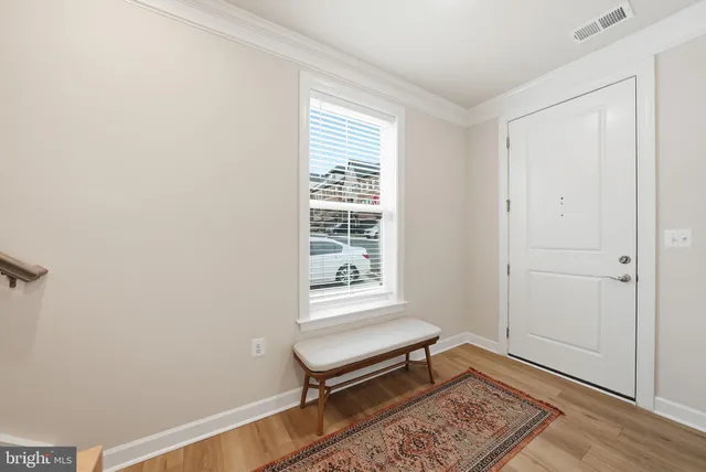 a bench sitting in a room next to a window
