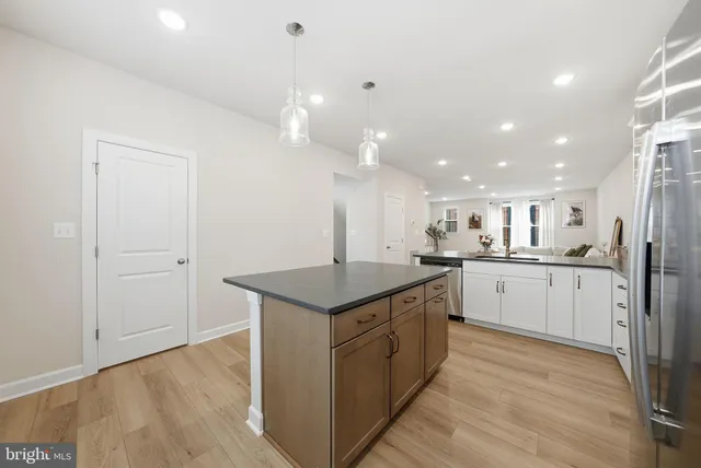 a kitchen with a sink window and stainless steel appliances