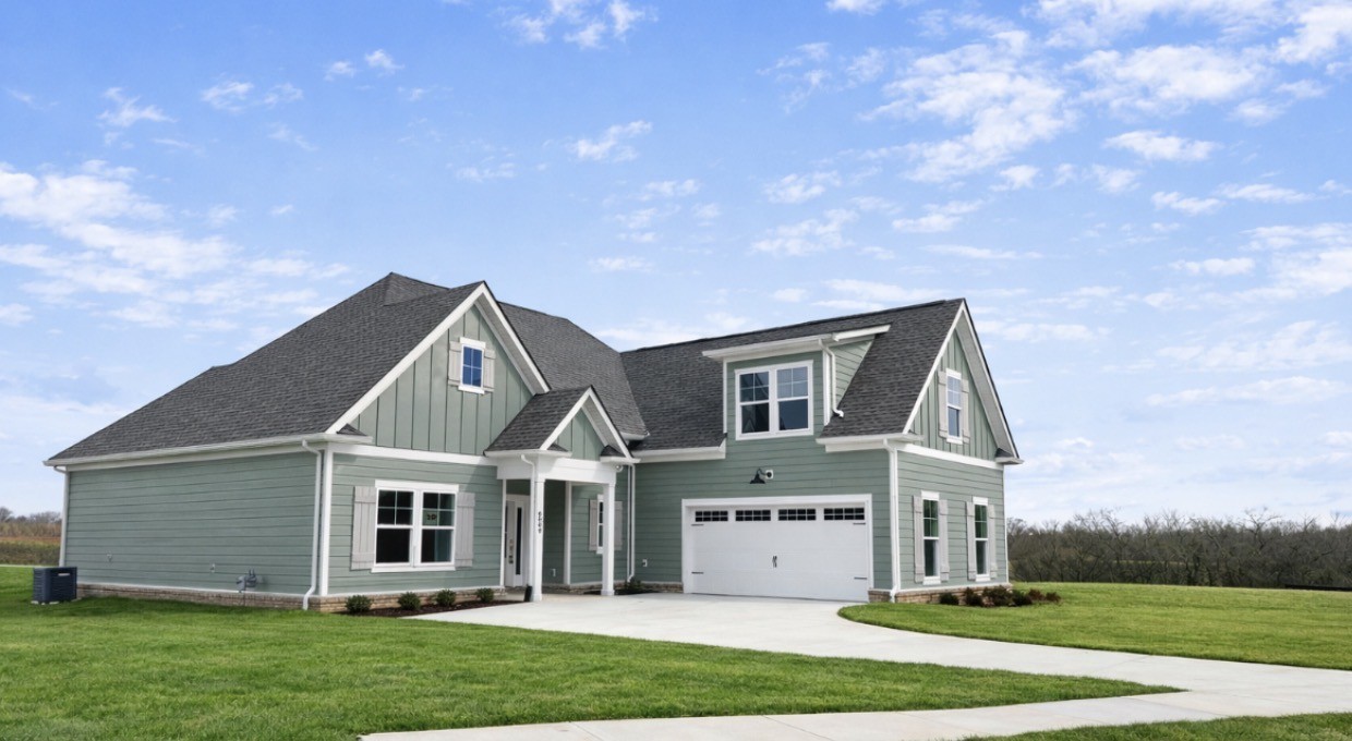 a front view of house with yard and green space