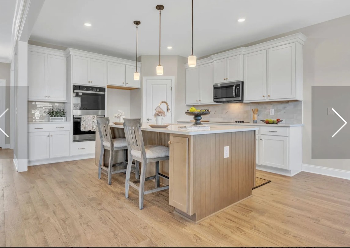 6509 Ripple Ridge Columbia, TN 38401 - Photo 11 of 20 a kitchen with stainless steel appliances granite countertop a sink a stove a refrigerator and a dining table with wooden floor
