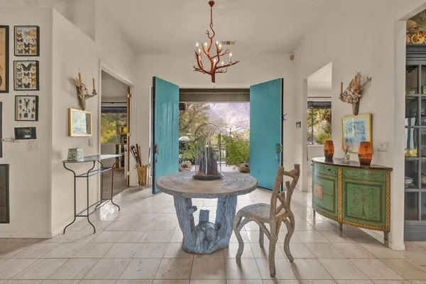 a view of a dining room with furniture and a chandelier