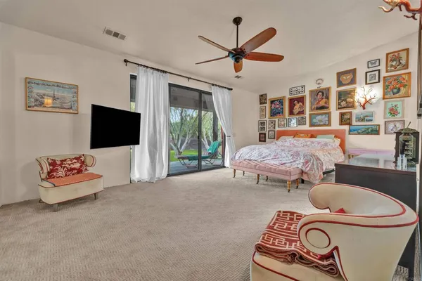 a bedroom with furniture and a flat screen tv