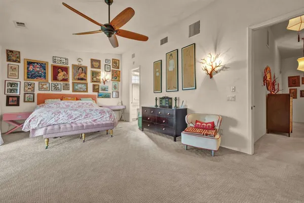 a bedroom with furniture and a chandelier