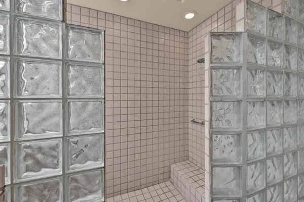 a bedroom with a bed a bookshelf and a window