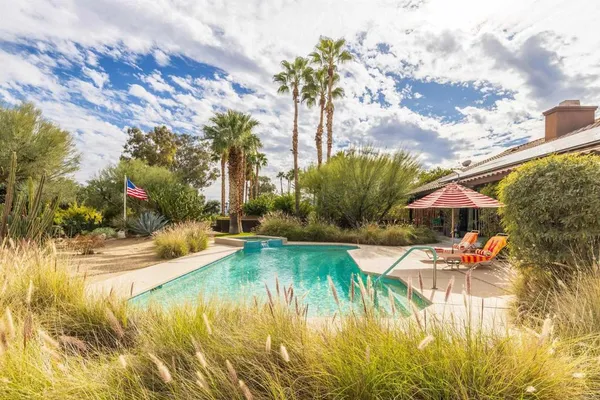 a view of a table and chairs under an umbrella