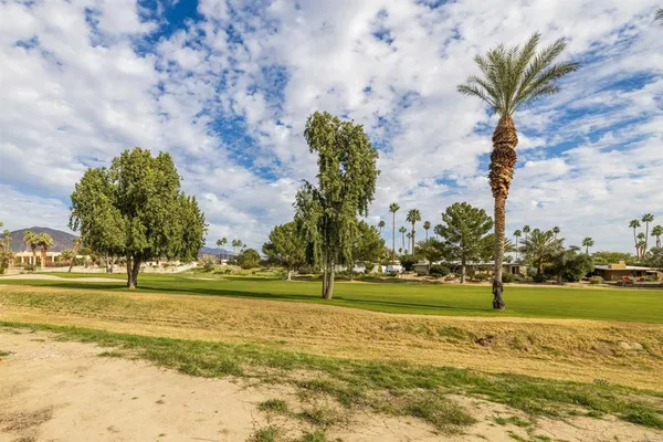 an aerial view of residential houses with outdoor space and swimming pool