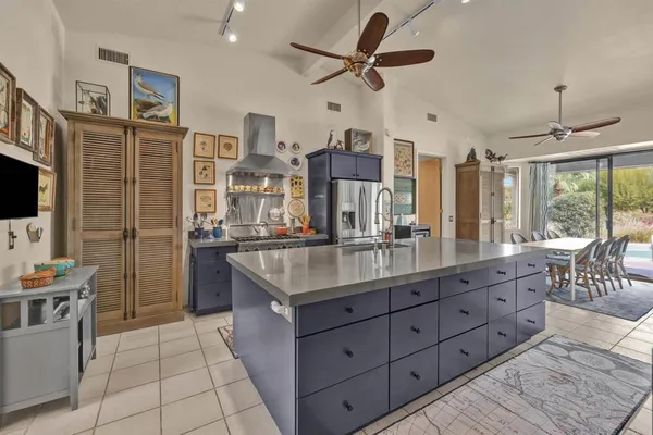 a kitchen with stainless steel appliances granite countertop a stove a sink and a refrigerator
