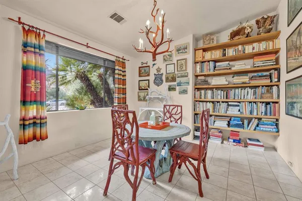 a dining room with furniture and a book shelf