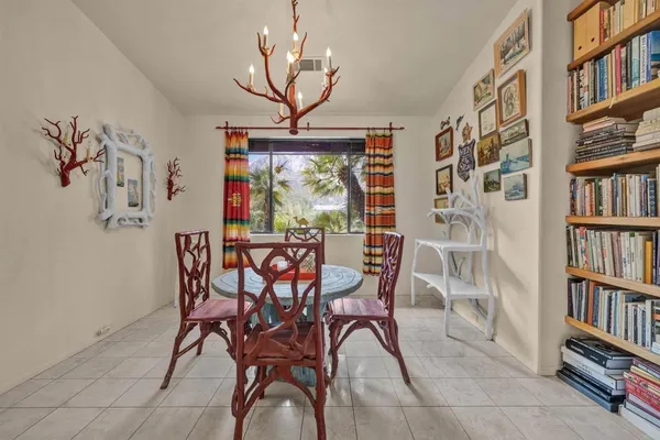 a view of a dining room with furniture and book shelf