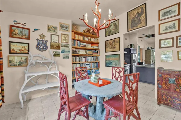 a view of a dining room with furniture and a chandelier