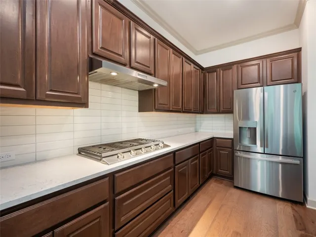 a kitchen with stainless steel appliances granite countertop a refrigerator sink and cabinets