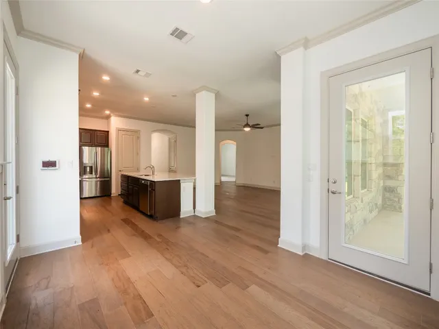 a view of a kitchen with wooden floor and a kitchen