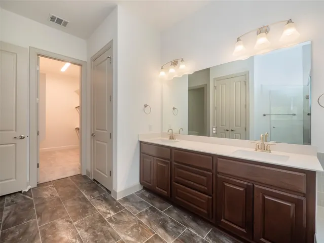 a spacious bathroom with a double vanity sink mirror and double