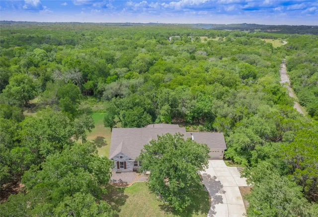 an aerial view of a house with a yard