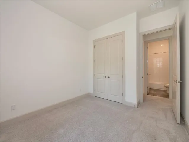 an empty room with a bench and a sink