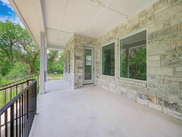a view of a room with a large window and wooden roof